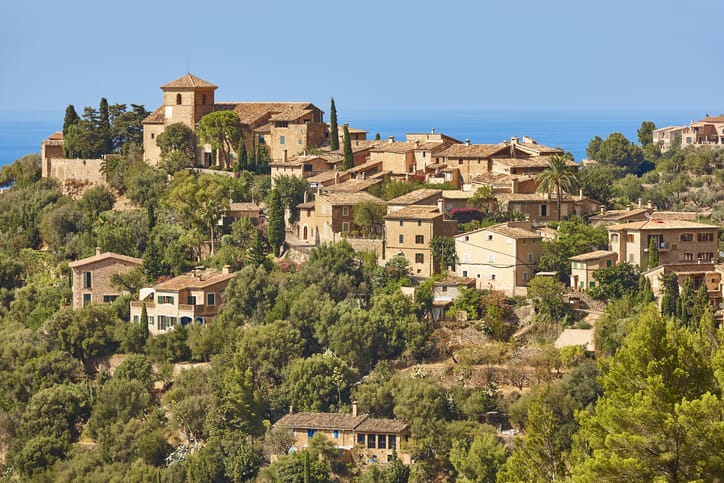 Traditional stone houses and tramuntana mountains in Deia. Mallorca, Spain
