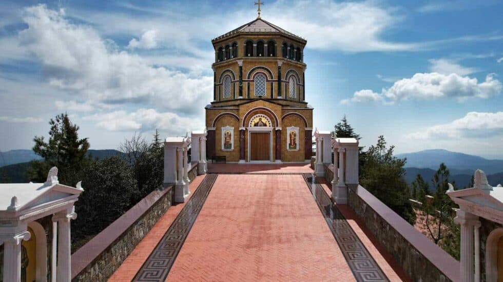 Kykkos Monastery, ornately decorated with a tiled path leading up to it.