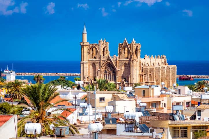 Towns in visit in Cyprus: Famagusta town with mosque and blue sea.