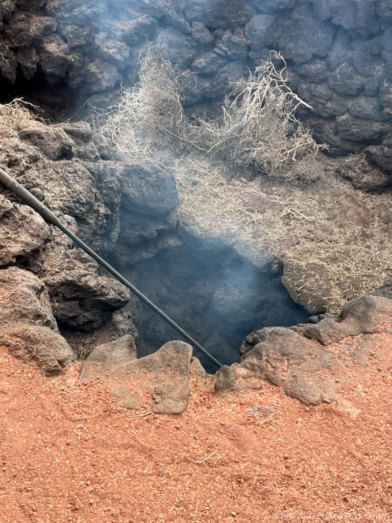 A fire pit with smoke and volcanic rock