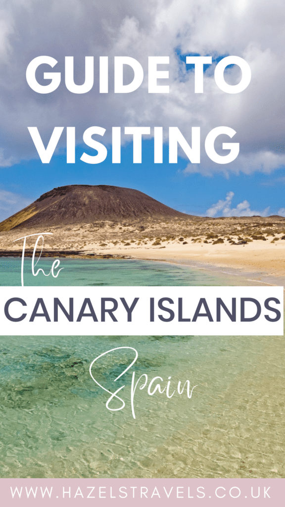 A sandy beach with clear turquoise water and a volcanic hill under a blue sky, overlaid with text about visiting the Canary Islands, Spain—discover which Canary Island is best for your next unforgettable getaway.