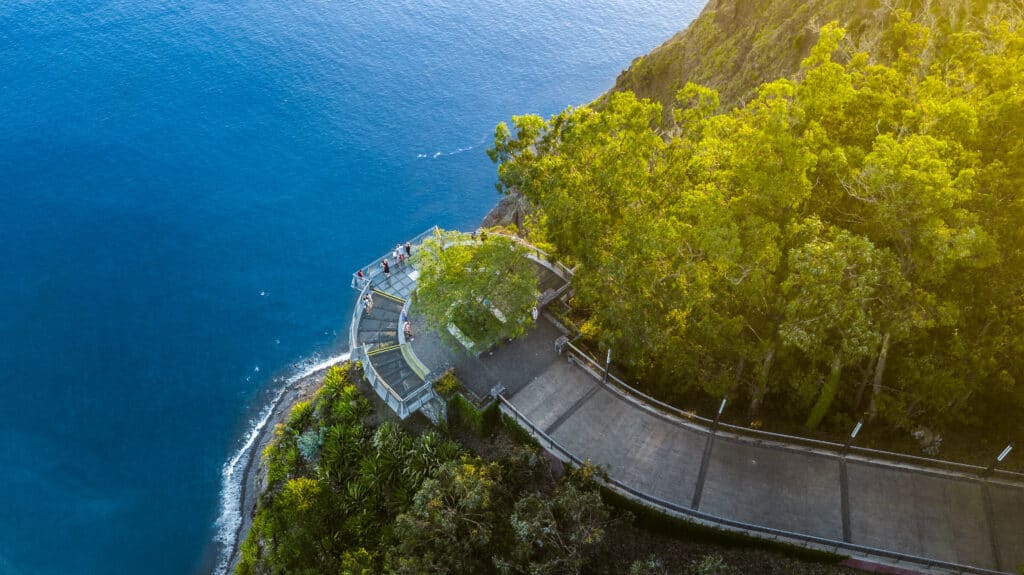 An aerial view of a walkway on a cliff overlooking the ocean.