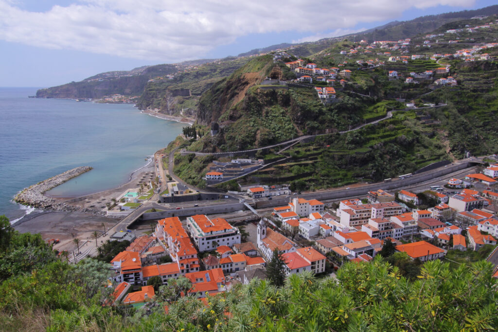 A view of a town on a cliff overlooking the ocean in Madeira.