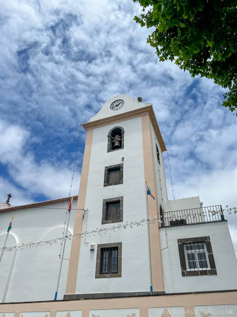 A white building with a clock tower.