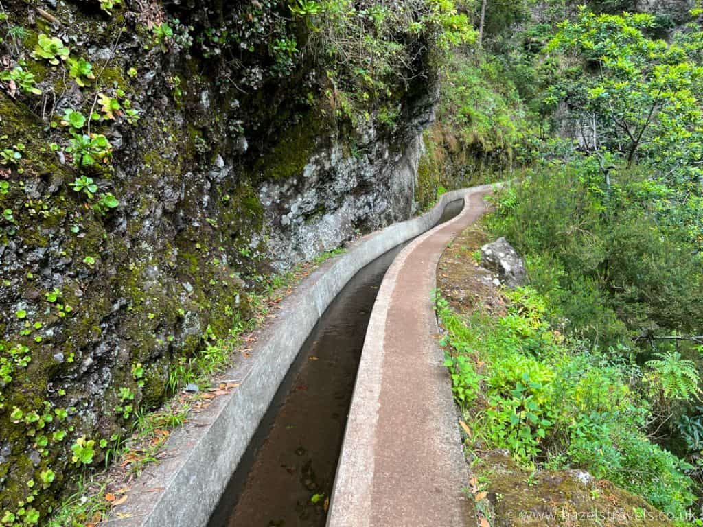 A narrow path leading down a rocky hillside.