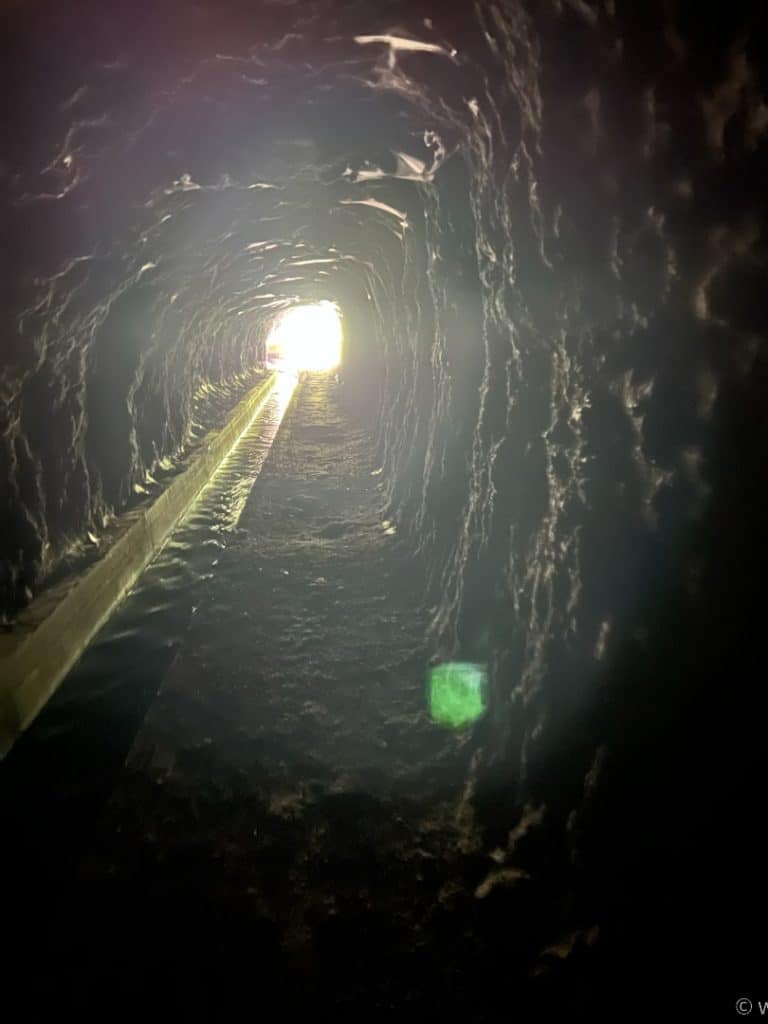 A tunnel with a light shining through it.