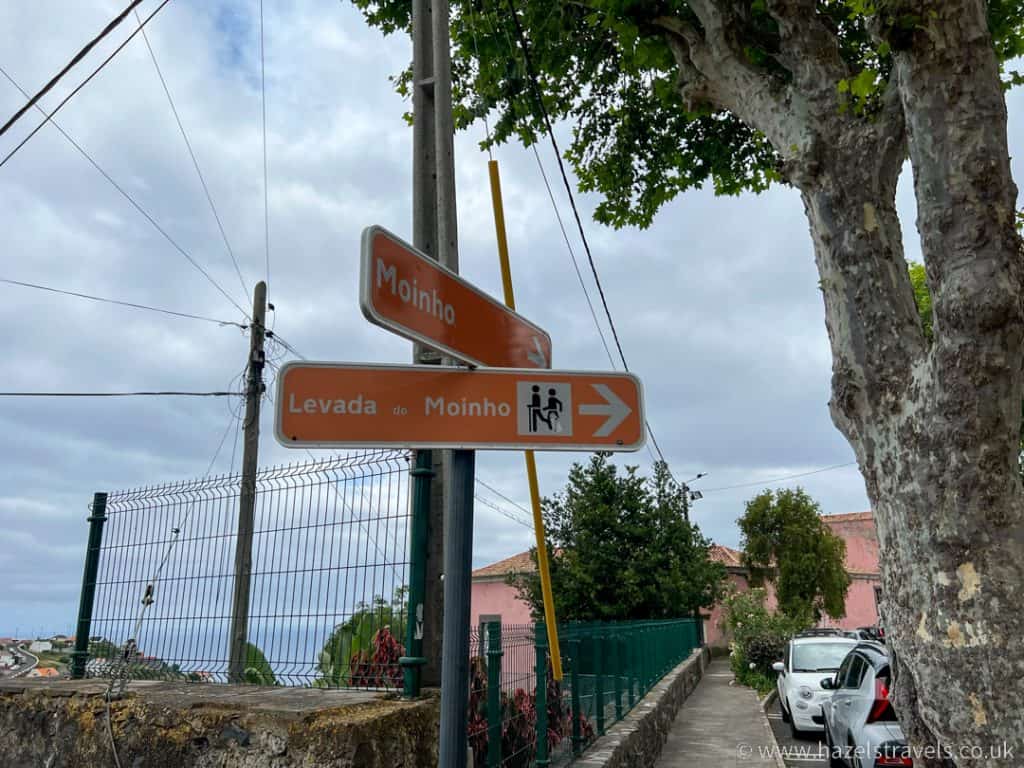 A street sign with two arrows pointing in different directions, indicating the directions of "levada do moinho".